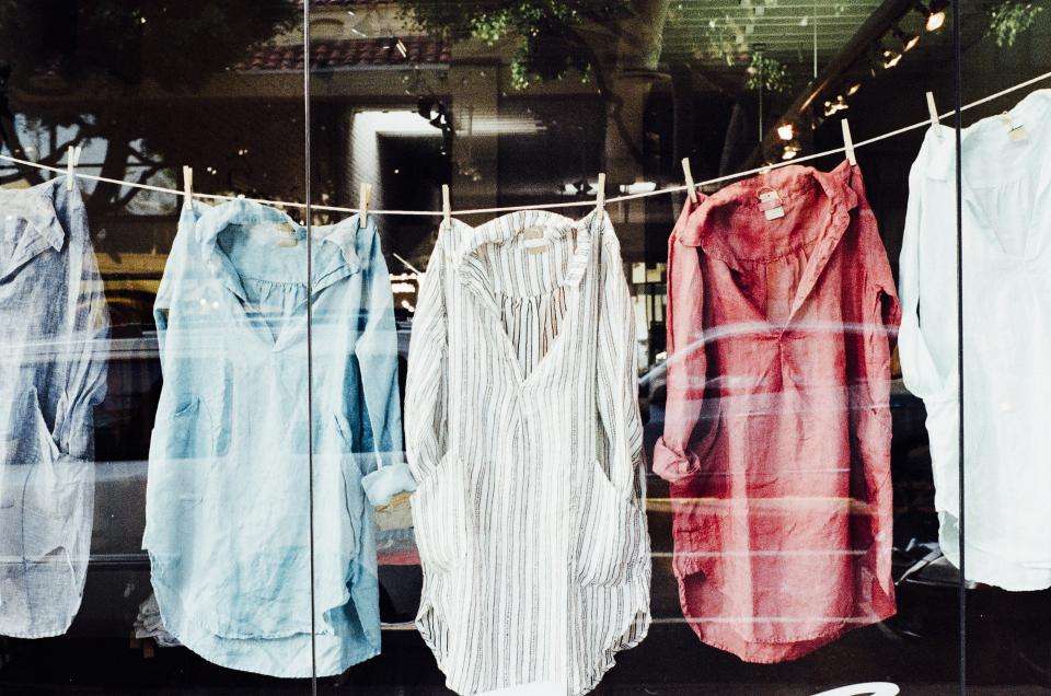 Light blue, white and red shirts hanging on a washing line
